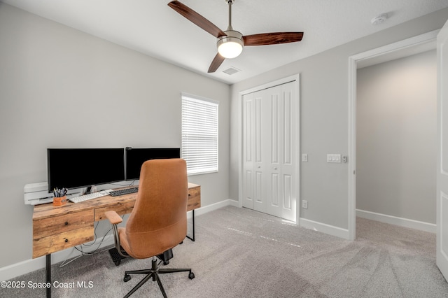 office area with baseboards, carpet flooring, ceiling fan, and visible vents