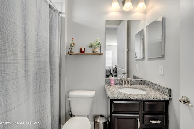 full bath with vanity, a shower with shower curtain, and toilet