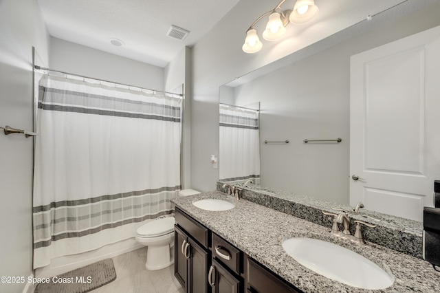 full bath featuring visible vents, a sink, double vanity, and toilet