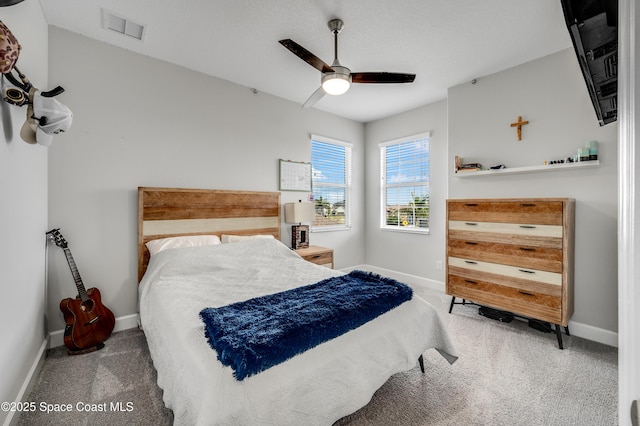 bedroom with visible vents, carpet, baseboards, and a ceiling fan