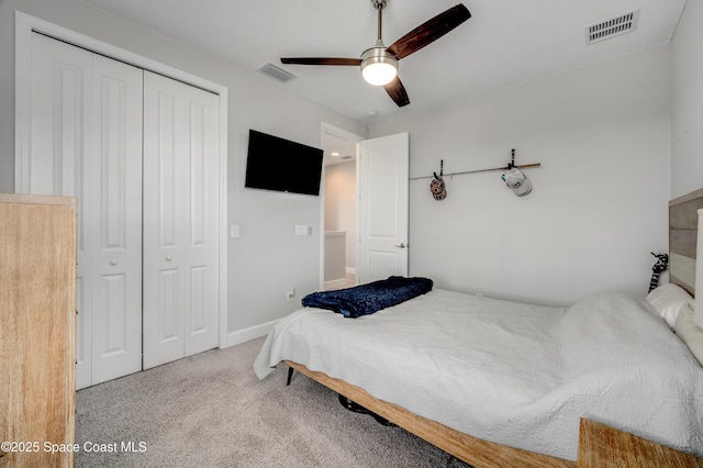 bedroom with ceiling fan, visible vents, baseboards, a closet, and carpet flooring