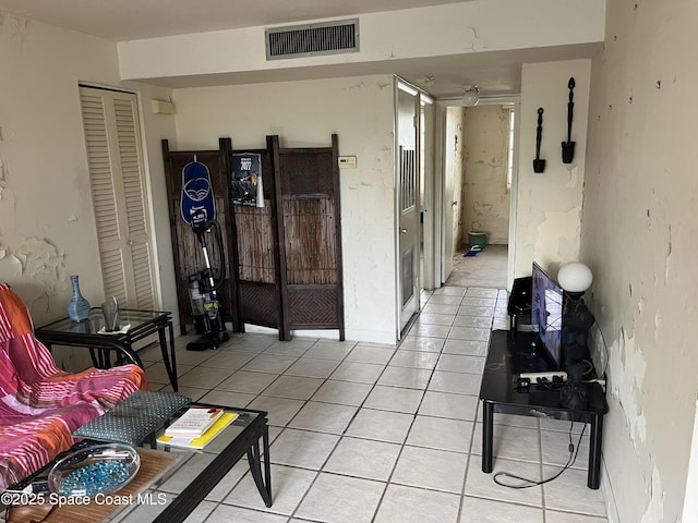 living room with light tile patterned flooring and visible vents