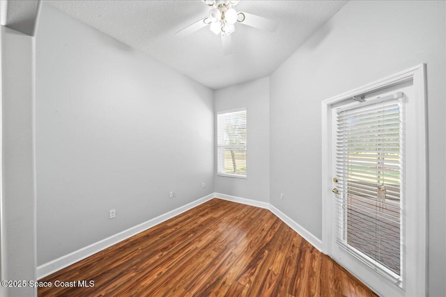 unfurnished room featuring a textured ceiling, baseboards, a ceiling fan, and wood finished floors