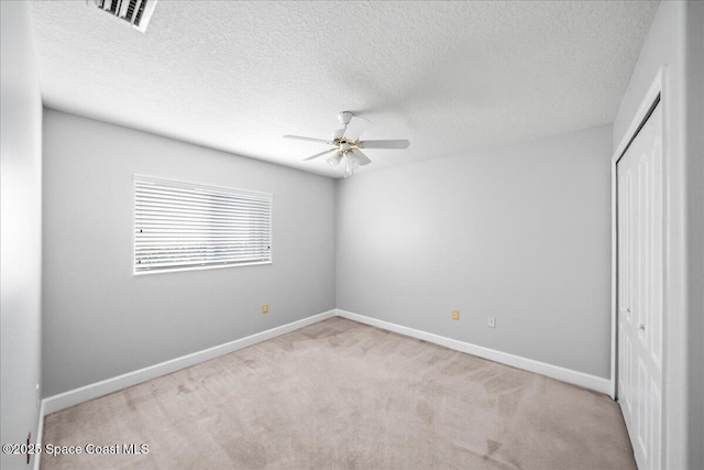 unfurnished bedroom featuring baseboards, carpet, a closet, and visible vents