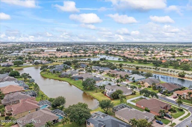 drone / aerial view featuring a water view and a residential view