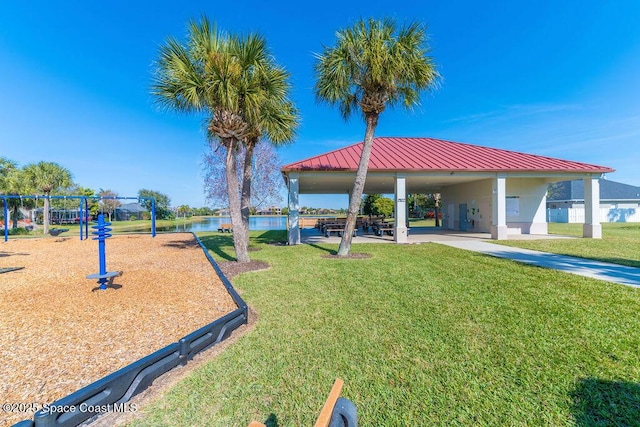view of property's community with a lawn, a water view, playground community, and a gazebo
