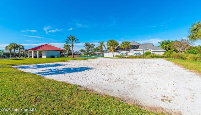 surrounding community featuring a yard and volleyball court