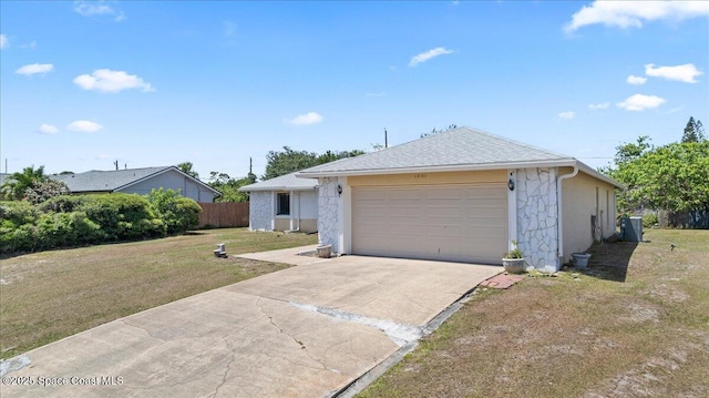 ranch-style home with fence, a front yard, concrete driveway, an attached garage, and central air condition unit