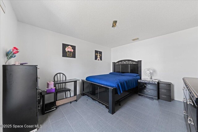 bedroom featuring a textured ceiling