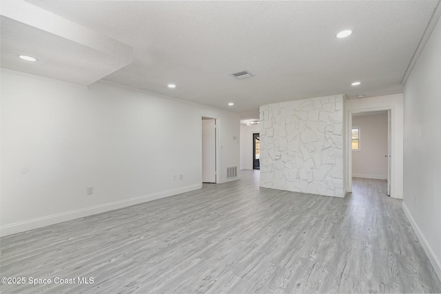 unfurnished living room featuring baseboards, light wood-type flooring, recessed lighting, and visible vents