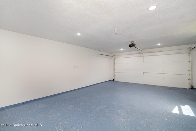 garage featuring a garage door opener and recessed lighting
