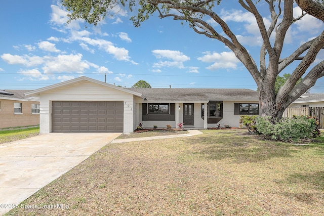 ranch-style home featuring a front lawn, fence, brick siding, an attached garage, and driveway