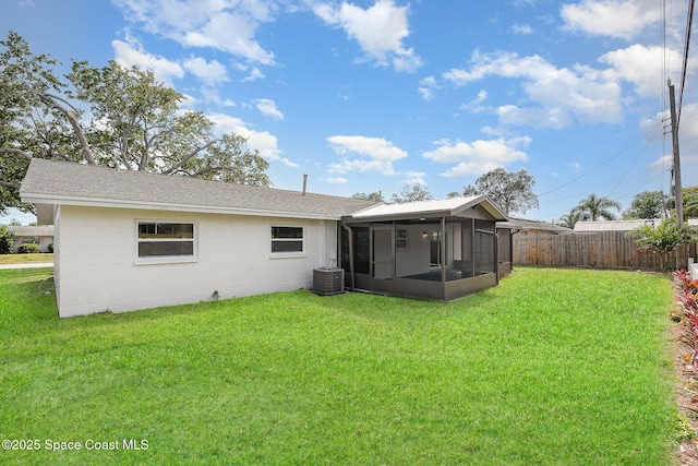 906 Kings Post Rd, Rockledge, FL 32955 - rear view of house with a sunroom, a shingled roof, and concrete block siding