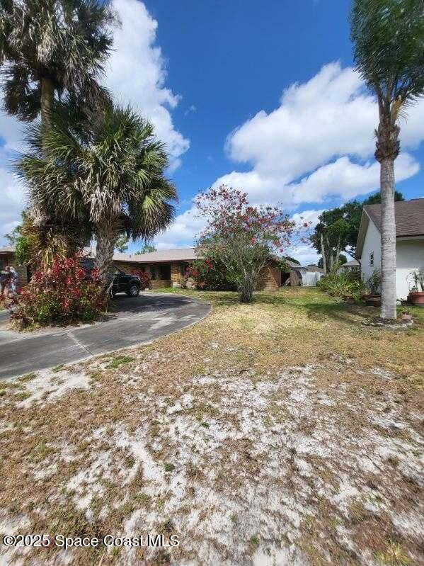 obstructed view of property featuring driveway