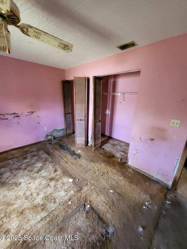 unfurnished bedroom with multiple closets and visible vents