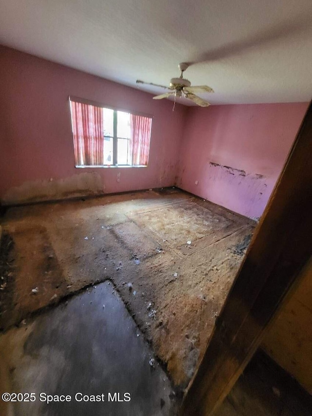 unfurnished room featuring a ceiling fan