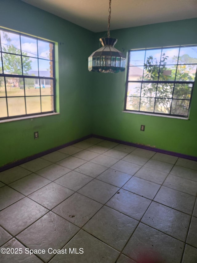 tiled empty room with baseboards
