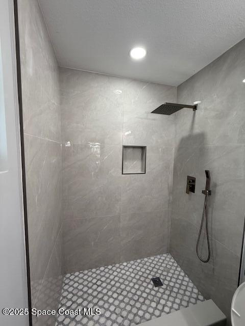full bathroom with a tile shower
