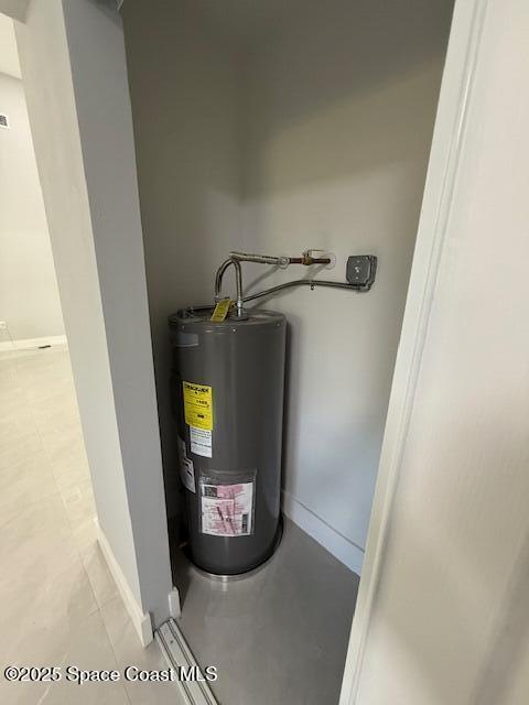 utility room featuring water heater