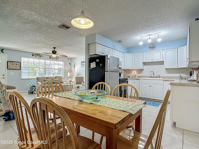 119 Landover Dr, Sebastian, FL 32958 - dining space with visible vents, a ceiling fan, a textured ceiling, and light tile patterned flooring
