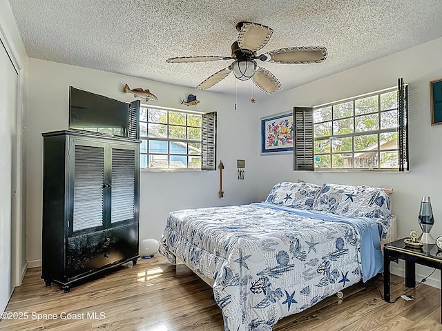 119 Landover Dr, Sebastian, FL 32958 - bedroom with a textured ceiling, ceiling fan, and wood finished floors
