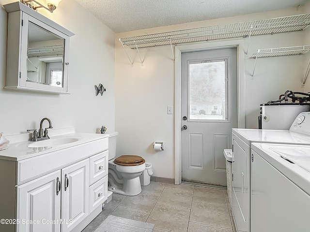 119 Landover Dr, Sebastian, FL 32958 - interior space with independent washer and dryer, laundry area, a sink, water heater, and baseboards