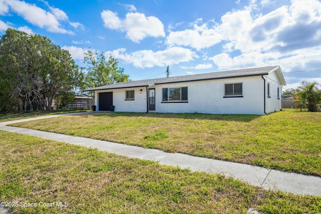 621 Plymouth St, Melbourne, FL 32935 - ranch-style home featuring a garage, driveway, and a front lawn