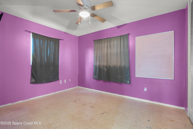 621 Plymouth St, Melbourne, FL 32935 - spare room with baseboards, a ceiling fan, and speckled floor