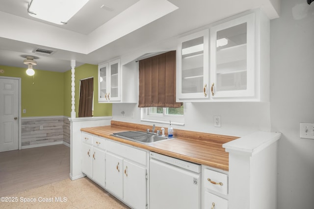 621 Plymouth St, Melbourne, FL 32935 - kitchen featuring white cabinets, wainscoting, a sink, dishwasher, and visible vents