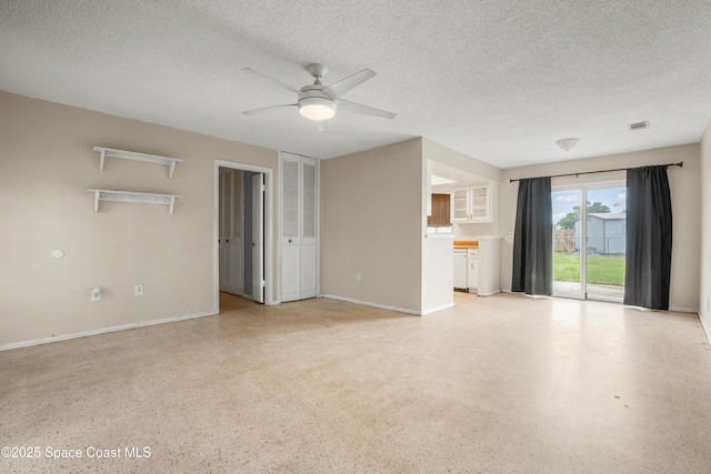621 Plymouth St, Melbourne, FL 32935 - unfurnished living room featuring a ceiling fan, a textured ceiling, and light speckled floor