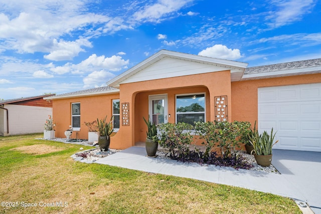 ranch-style home with a garage, stucco siding, and a front yard