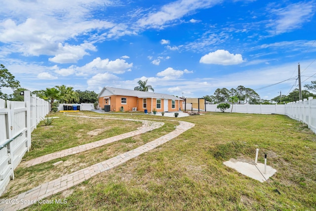 exterior space with a fenced backyard, a patio, and a lawn