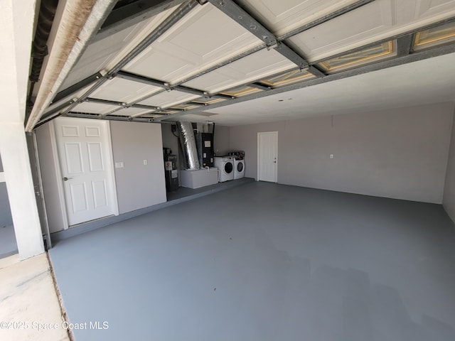 2175 Dumas St, Merritt Island, FL 32952 - garage featuring separate washer and dryer, water heater, and heating unit