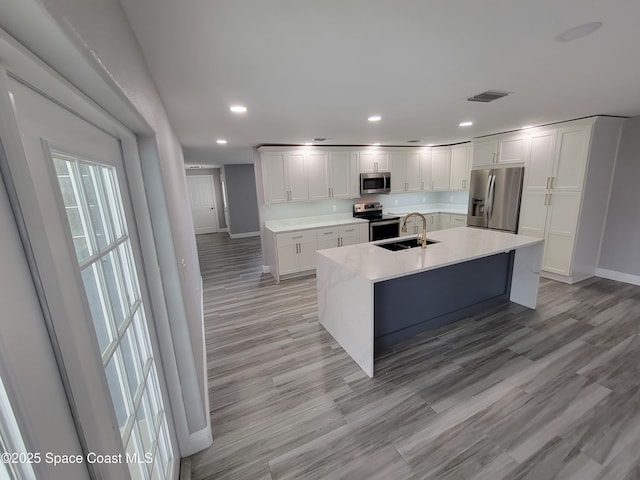 2175 Dumas St, Merritt Island, FL 32952 - kitchen featuring appliances with stainless steel finishes, baseboards, a sink, recessed lighting, and white cabinets