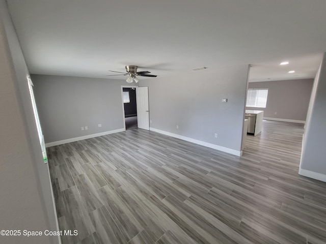 2175 Dumas St, Merritt Island, FL 32952 - spare room featuring ceiling fan, baseboards, wood finished floors, and recessed lighting