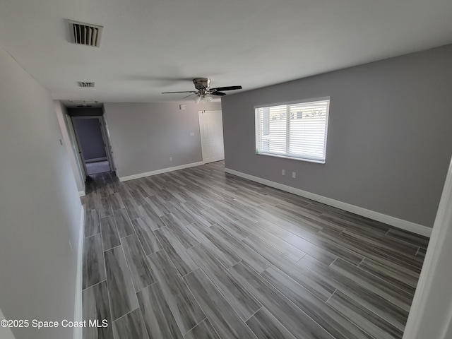 2175 Dumas St, Merritt Island, FL 32952 - unfurnished room featuring wood finished floors, baseboards, and a ceiling fan