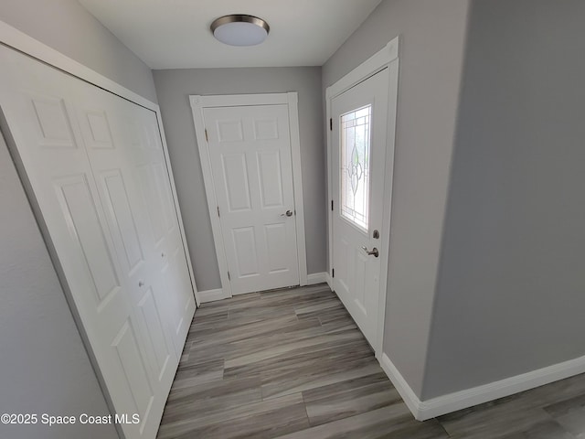 2175 Dumas St, Merritt Island, FL 32952 - doorway featuring baseboards and wood finished floors