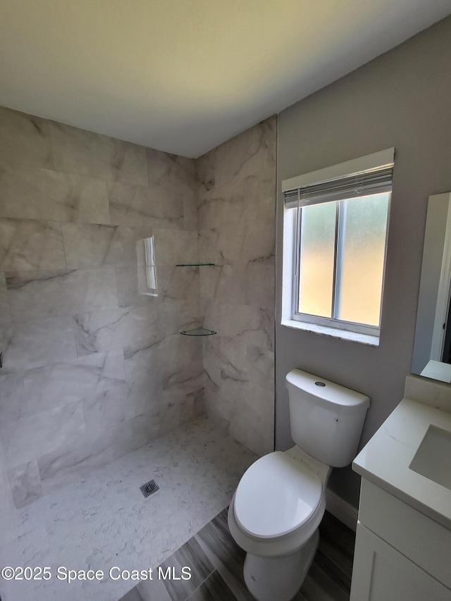 2175 Dumas St, Merritt Island, FL 32952 - full bathroom with vanity, toilet, a shower, and wood finished floors