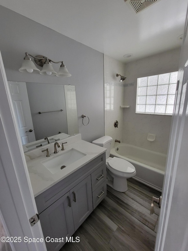 2175 Dumas St, Merritt Island, FL 32952 - full bathroom featuring shower / bath combination, vanity, wood finished floors, and toilet