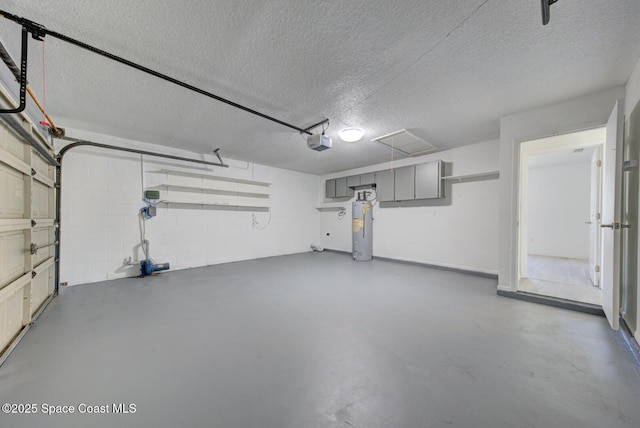 garage featuring concrete block wall, a garage door opener, and electric water heater