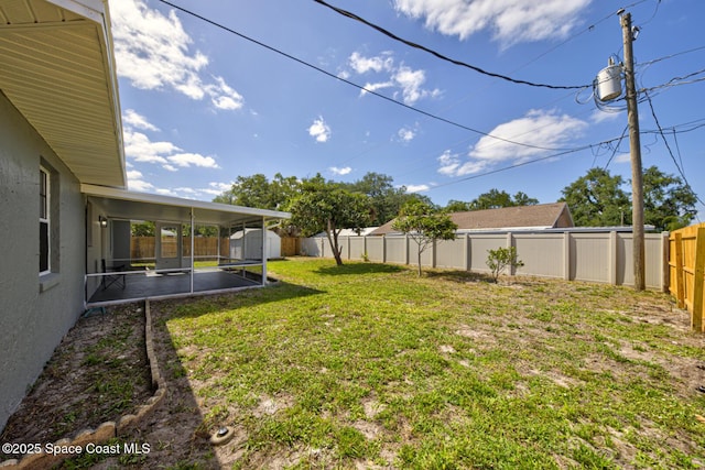 view of yard with a sunroom and a fenced backyard