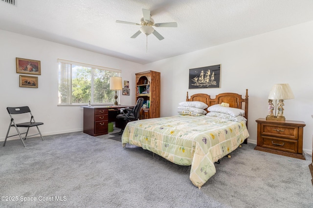 carpeted bedroom with a textured ceiling, baseboards, visible vents, and ceiling fan