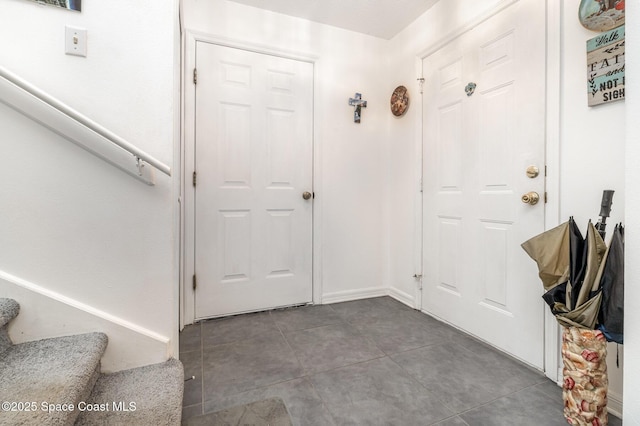 foyer with stairs and tile patterned floors