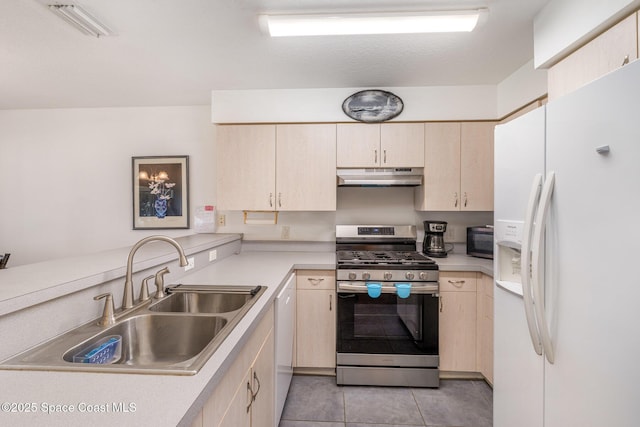 kitchen featuring a sink, light countertops, under cabinet range hood, and white appliances