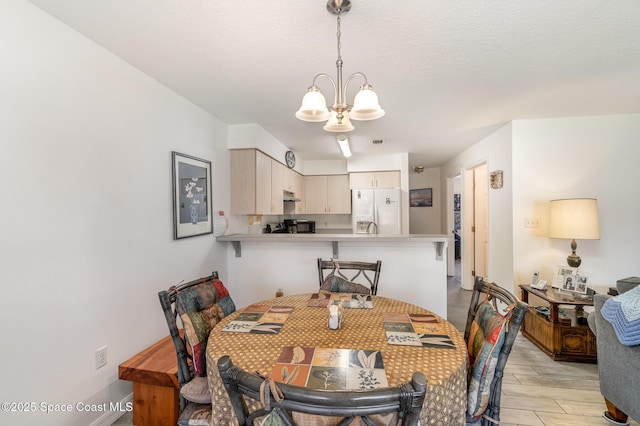 dining room with an inviting chandelier and light wood finished floors