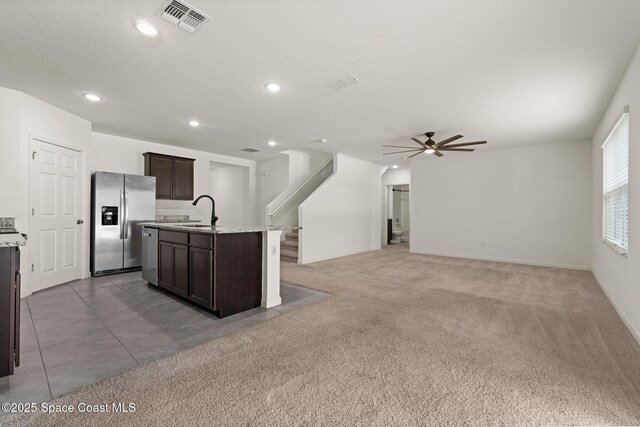 kitchen with stainless steel appliances, dark brown cabinetry, a sink, recessed lighting, and ceiling fan