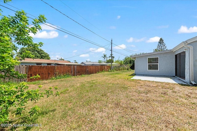 view of yard with fence and a patio area
