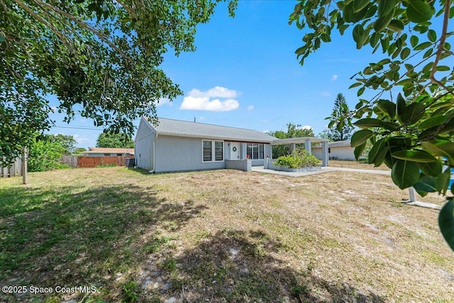 single story home with fence, a patio area, and a front yard
