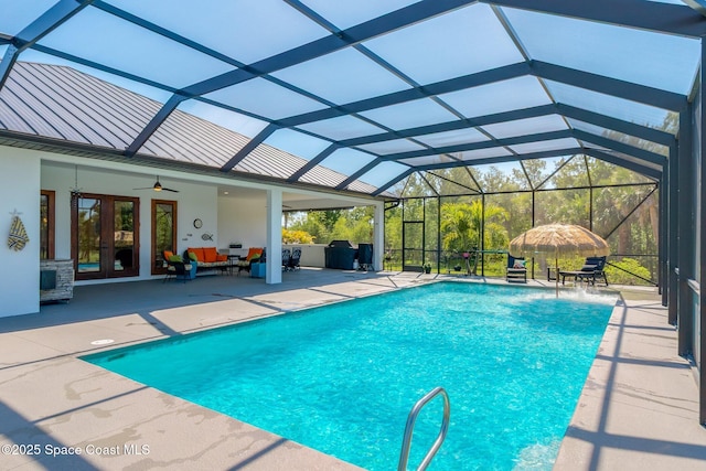 outdoor pool featuring a lanai, a patio, a ceiling fan, and french doors