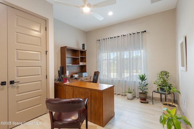 home office with light wood-type flooring, baseboards, and ceiling fan